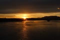 Sunset silhouettes Canadian islands and sun glittering off the water