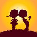 Sunset silhouettes of kissing boy and girl Royalty Free Stock Photo