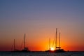 Sunset silhouetting three sailboats silhouetted by the sunset in the Mediterranean Sea Royalty Free Stock Photo