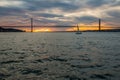 Sunset sky above Tagus River, Bridge April 25 Lisbon and port at from ship, Portugal. Royalty Free Stock Photo