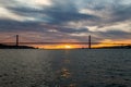 Sunset sky above Tagus River, Bridge April 25 Lisbon and port at from ship, Portugal. Royalty Free Stock Photo