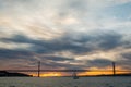 Sunset sky above Tagus River, Bridge April 25 Lisbon and port at from ship, Portugal. Royalty Free Stock Photo