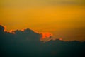 sunset sky back on dark silhouette cloud and orange of sun ray Royalty Free Stock Photo