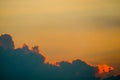 sunset sky back on dark silhouette cloud and orange of sun ray Royalty Free Stock Photo