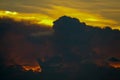 sunset sky back on dark silhouette cloud red lava flame hole of sun ray last light Royalty Free Stock Photo