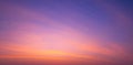 Sunset sky background with beautiful pink sunrise clouds on colorful dramatic twilight sky in panoramic view Royalty Free Stock Photo