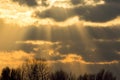 Sunset sky background image. Orange sunlight rays through cloud. Royalty Free Stock Photo