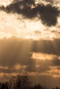 Sunset sky background, Sun behind dark cloud with crepuscular ra Royalty Free Stock Photo