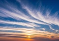 Sunset sky with cirrus clouds creating sweeping patterns across Royalty Free Stock Photo