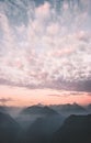 Sunset sky clouds over mountains range peaks Royalty Free Stock Photo