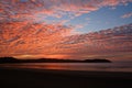 Sunset sky with colorful clouds over ocean at beach - Royalty Free Stock Photo