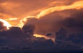 Sunset sky. Golden light shine in layers of clouds. Fluffy clouds at dusk. Twilight sky. God light. Cloudscape. Beauty in nature. Royalty Free Stock Photo