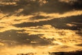 Sunset sky with golden rays of the sun against the background of silhouettes of mountain landscapes and rural villages. Aerial