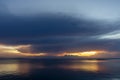 Sunset sky at the lake with rain cloud and light in golden hour Royalty Free Stock Photo