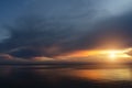 Sunset sky at the lake with rain cloud and light in golden hour Royalty Free Stock Photo