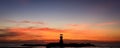 Sunset sky and a lighthouse silhouette