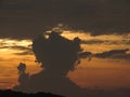 a sunset sky and an oddly strange shaped dark cloud