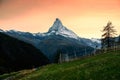 Sunset sky over Matterhorn mountain on Swiss Alps and stall of sheep on hillside in rural scene Royalty Free Stock Photo