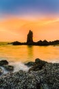 Sunset sky over seacoast rock on the beach Royalty Free Stock Photo