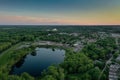 Sunset Sky Over Small Lake in Town Spring Aerial