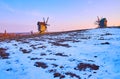 The sunset sky over the snowy field with windmills on horizon, Pyrohiv Skansen, Kyiv, Ukraine