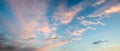 Sunset sky panorama with feathery clouds, pink lighted from last sun rays