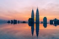 Sunset sky pink/orange view to the modern business center downtown city with a skyscrapers towers reflected in top roof infinity Royalty Free Stock Photo