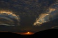 Sunset sky with punch hole clouds