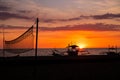 Sunset sky and sea landscap. Wooden boat and volleyball net. Evening seascape on tropical island. Summer vacation travel