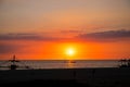 Sunset sky and sea landscape with wooden boat. Romantic seascape on tropical island. Summer vacation travel card Royalty Free Stock Photo