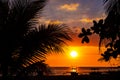 Sunset sky and sea landscape with wooden boats. Romantic seascape on tropical island. Orange sunset sky banner template Royalty Free Stock Photo