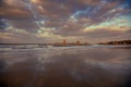 Sunset sky's reflection through the wet sand on the ocean beach and Penglai immortals pavilion, Yantai, Shandong, China Royalty Free Stock Photo