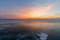 Sunset skyline over frozen water lake in winter season Royalty Free Stock Photo