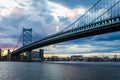 sunset skyline of philadelphia pennsylvania from camden new jersey with benjamin franklin bridge Royalty Free Stock Photo