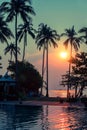 Sunset on a small tropical beach surrounded by palm trees. Nature. Royalty Free Stock Photo