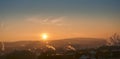 Sunset with smoke and condensation trails