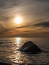 Sunset Solitude: Tranquil Stone in Veczemju Klintis Seas