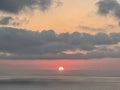 Sea, island Sun and clouds, beautiful coloration of the setting sun