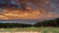 Sunset and storm clouds over forest Royalty Free Stock Photo