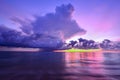 Sunset and storm front with rain over the sea