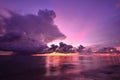 Sunset and storm front with rain over the sea