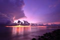 Sunset and storm front with rain over the sea