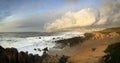 Sunset on the stormy Atlantic Ocean beach with city on the background near Porto, Portugal, January 2018 Royalty Free Stock Photo