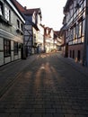 Sunset on the street with fachwerk houses, sun flares on the road