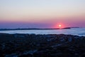 Sunset in the Atlantic Ocean over the Peniche isthmus, the island of Berlenga and the dunes of portuguese west coast