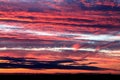 Sunset in the summer in the East of England. A layered gold, red and white sunset overlooking a nature reserve.