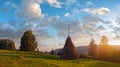 Sunset on summer mountainous green meadow with stack of hay (Slavske village, Carpathian Mts, Ukraine