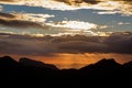 Sunset. The sun above the line of mountains Royalty Free Stock Photo