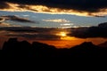 Sunset. The sun above the line of mountains Royalty Free Stock Photo