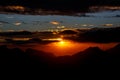 Sunset. The sun above the line of mountains Royalty Free Stock Photo